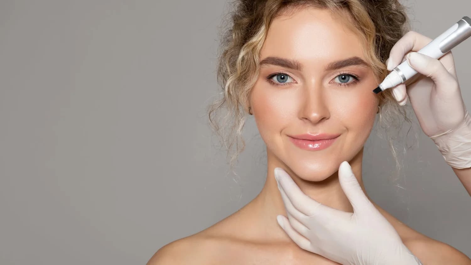 Aesthetic provider consulting with a patient inside an Advancing Aesthetics treatment suite