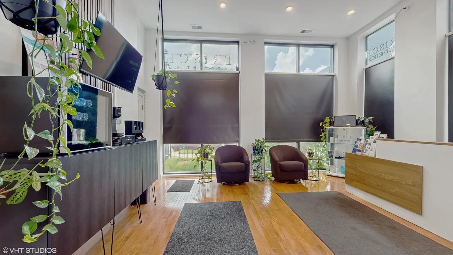 Treatment suite interior with device cart and consultation seating